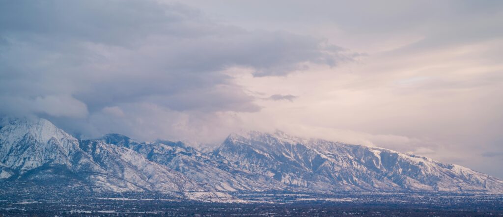 Snow-covered Wasatch Mountains in Salt Lake City, Utah during a serene spring sunset.