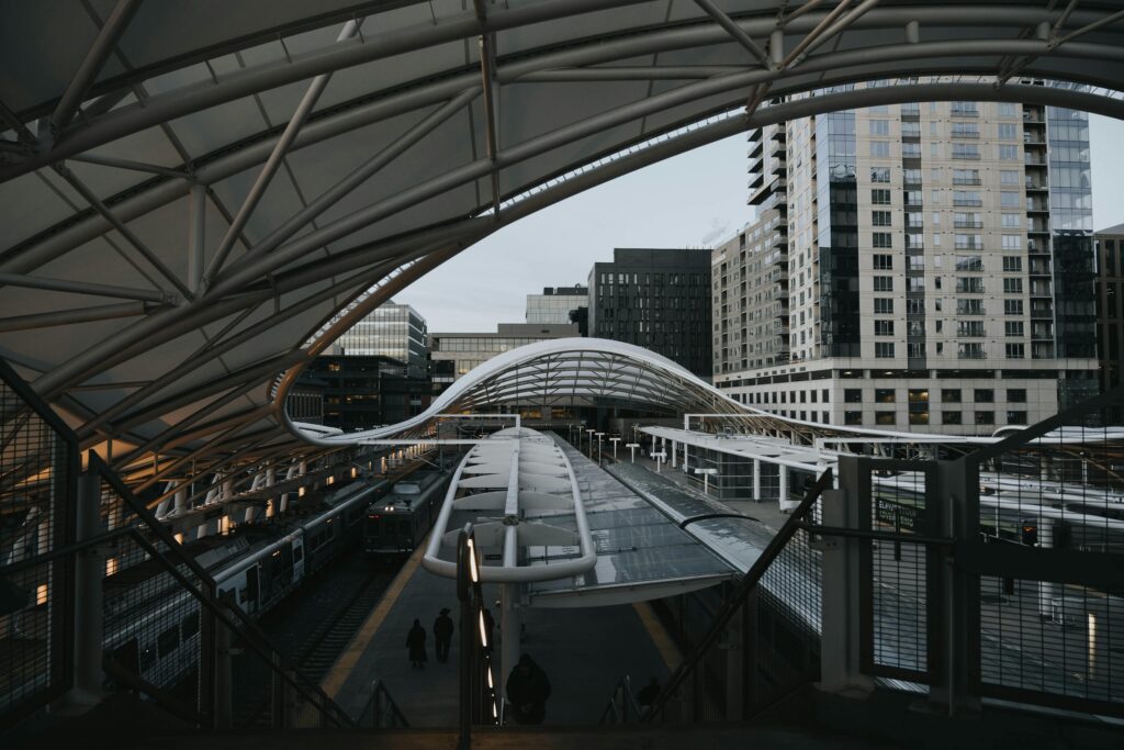 View of the sleek contemporary design at Denver Union Station with downtown buildings.