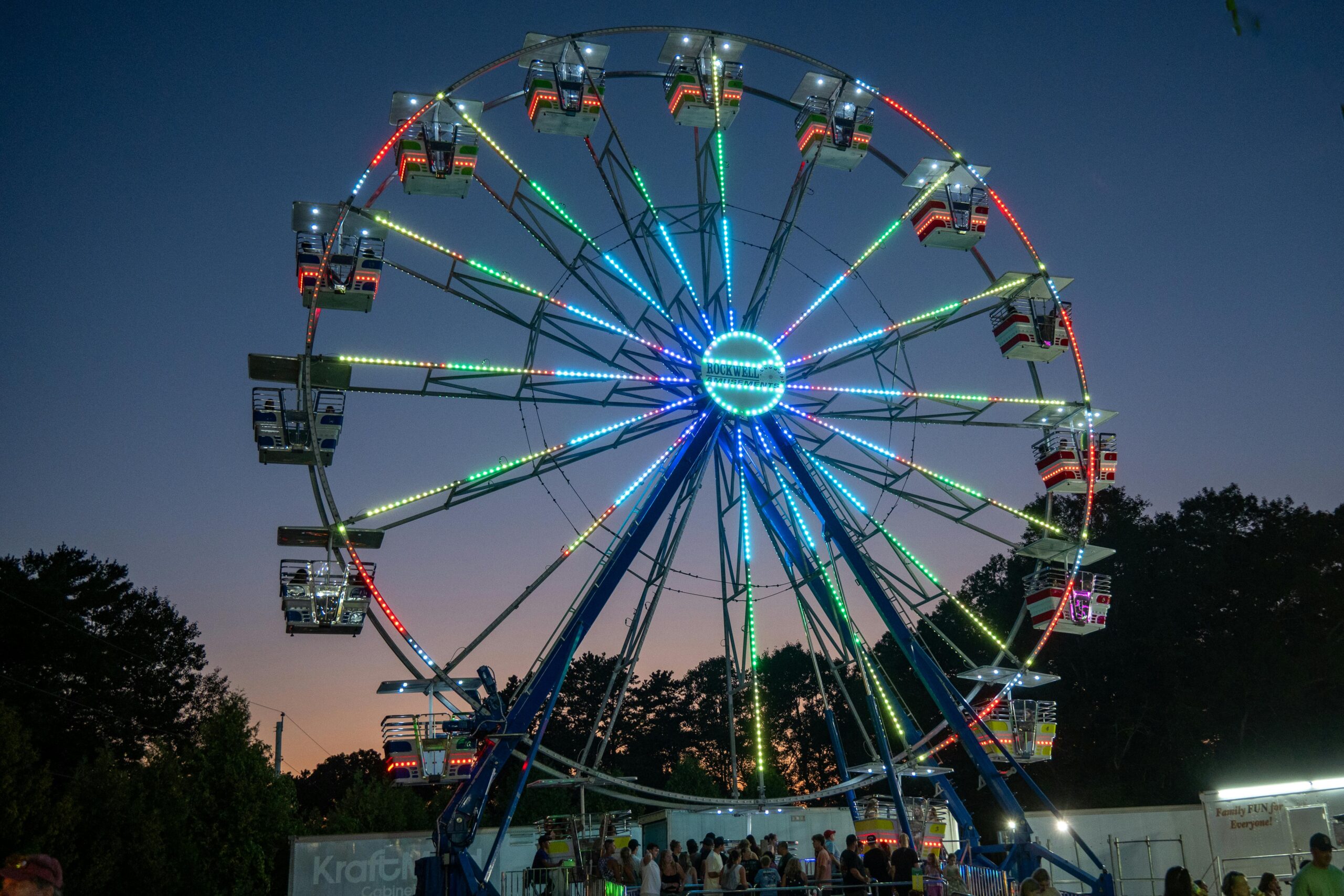 Colorful Ferris wheel illuminates the night sky at Washington County Fair in Richmond, Rhode Island.