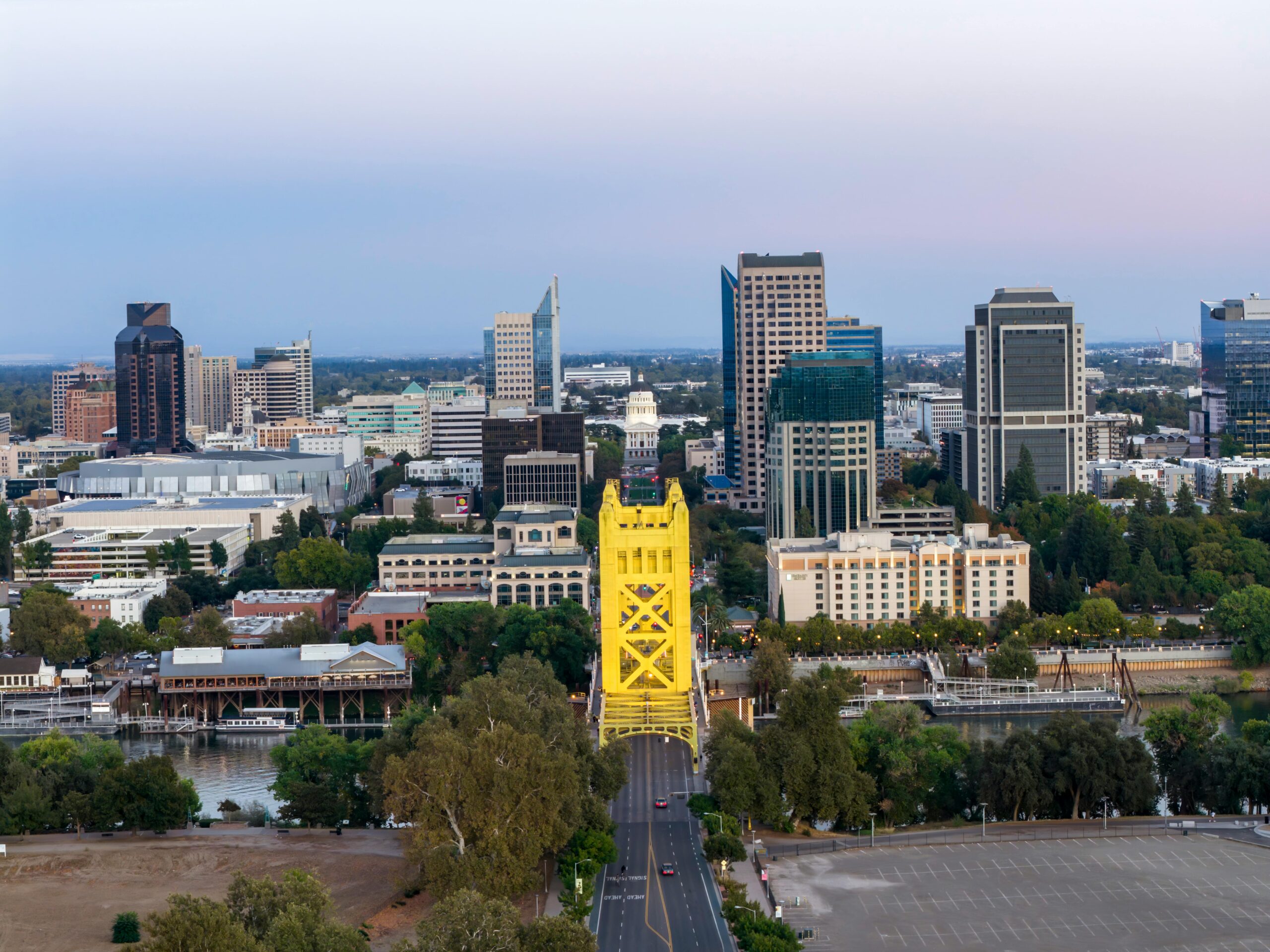 Aerial view of Sacramento showing the iconic Tower Bridge and city skyline at dusk.