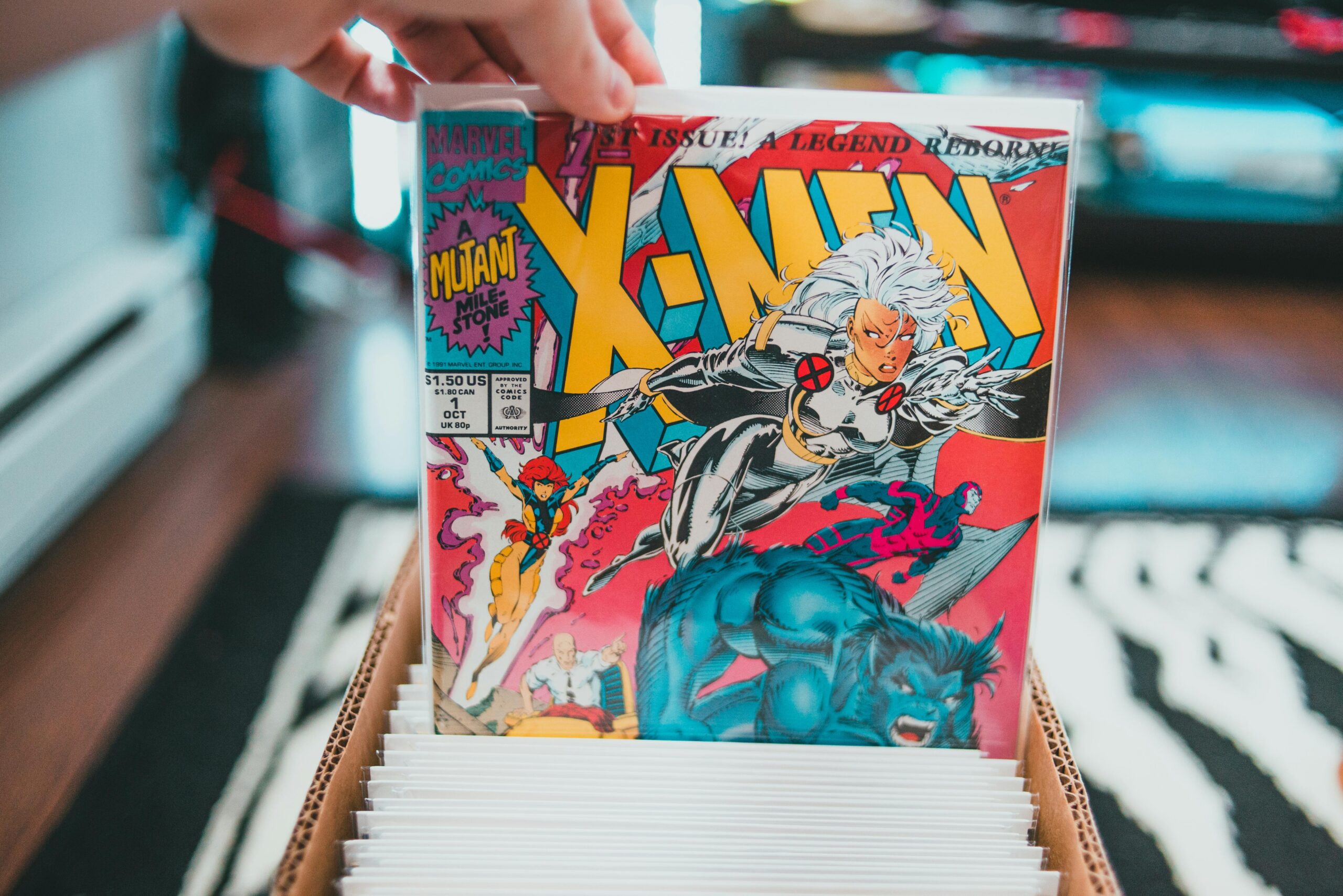 Crop anonymous person demonstrating collection of colorful comic books placed in box in living room