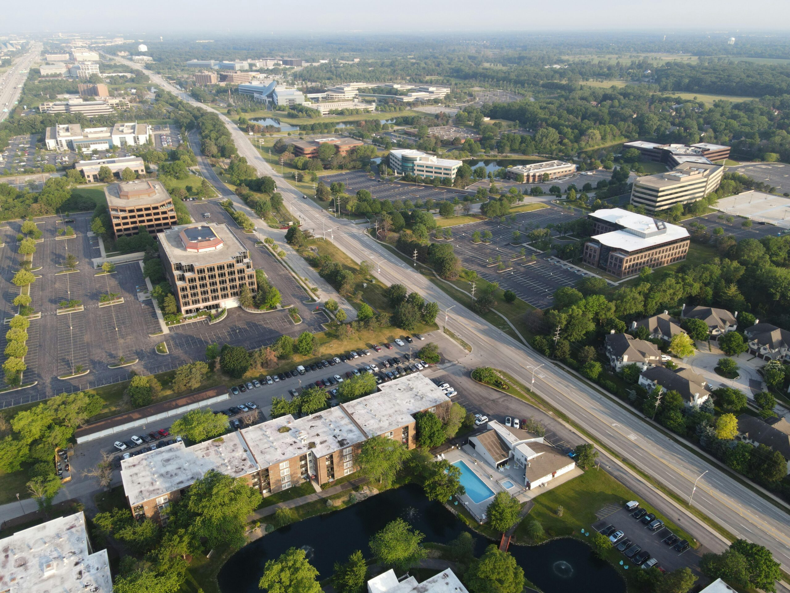 Aerial view showcasing the suburban business district in Lisle, Illinois, highlighting roads, buildings, and greenery.
