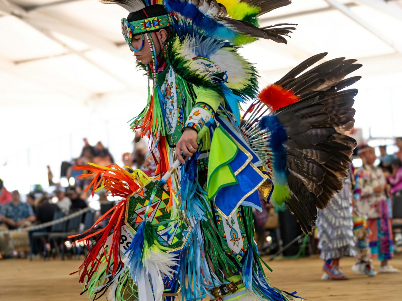 Dynamic capture of a Native American dancer in colorful regalia at a Cabazon, CA pow wow.