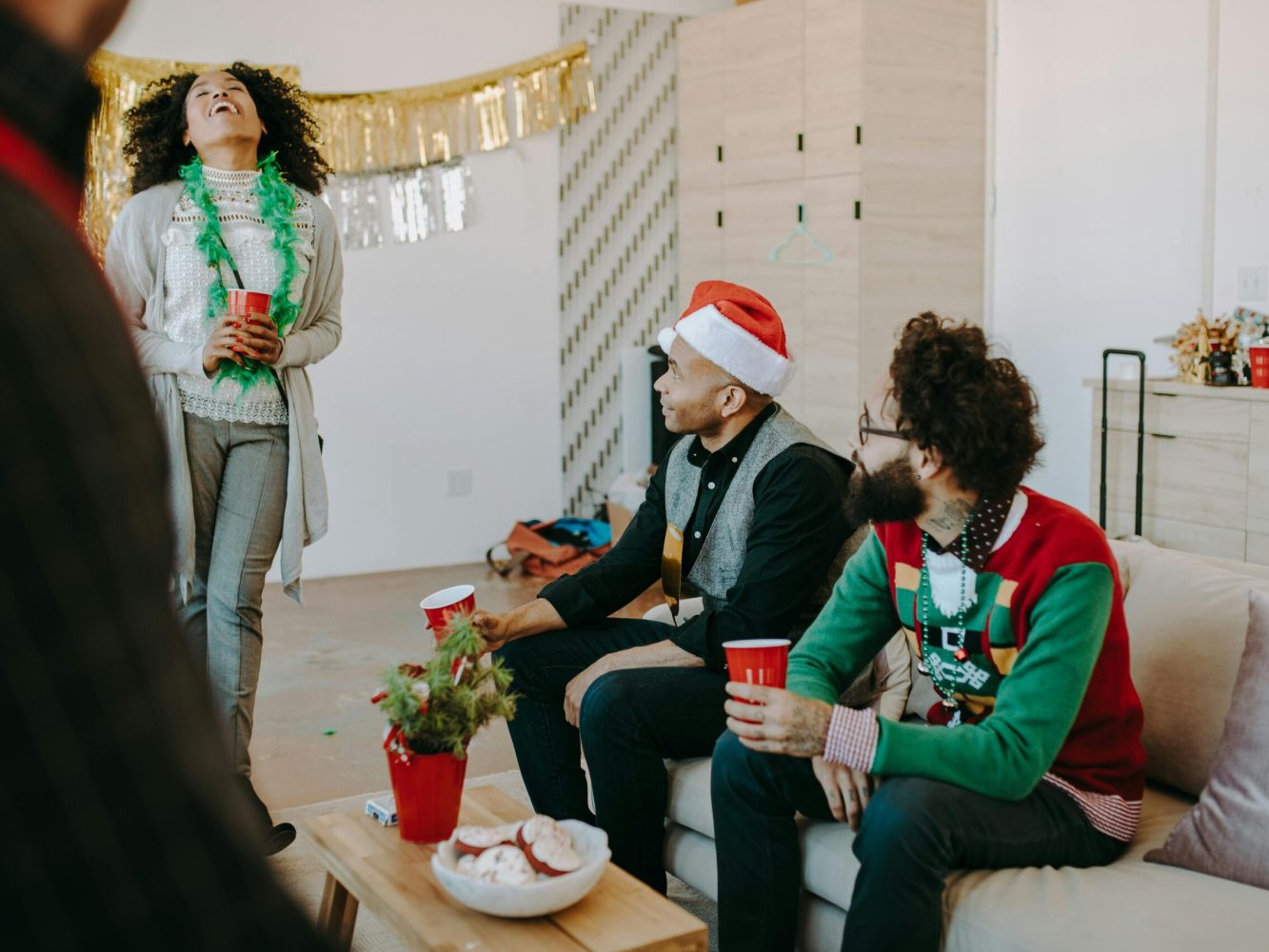 Festive office gathering with adults enjoying a Christmas party indoors.